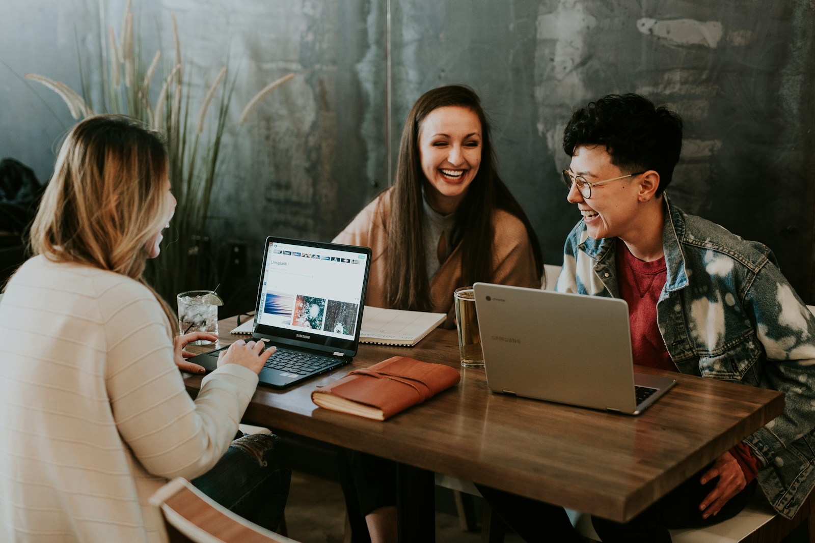A diverse group of adult students learning together around a table